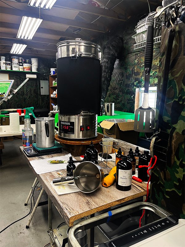 Photo of a worktable in a candle studio holding a commercial wax melter used for making scented Fire Mountain Candles container candles.